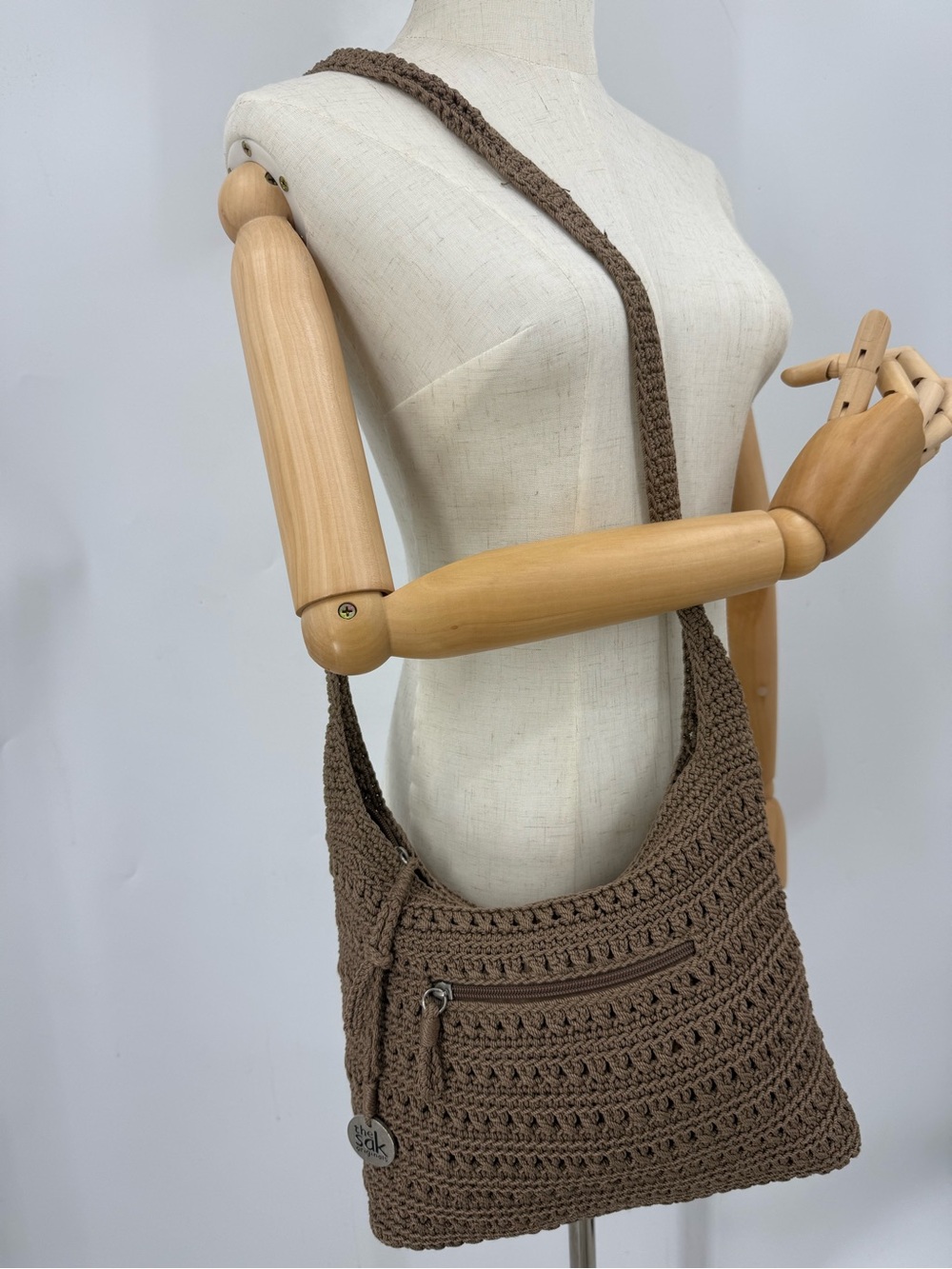The Sak Amberly Crochet Medium Hobo Bag in a neutral tan/brown shade